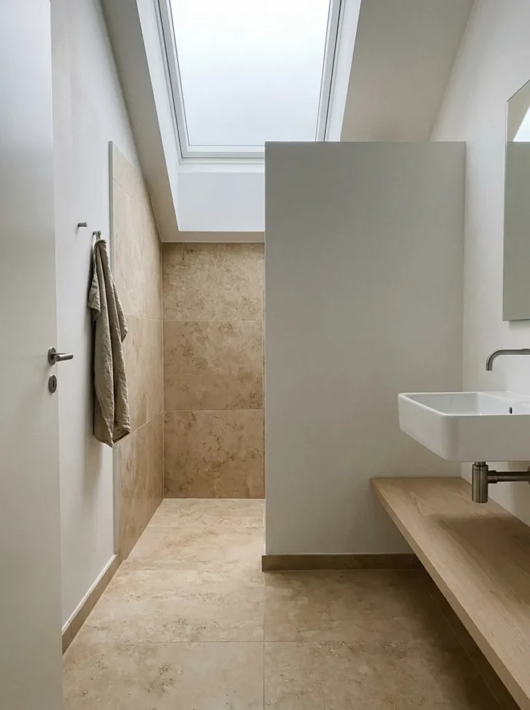 Elegant bathroom with large format floor tiles, minimal grout lines, and a spacious feel