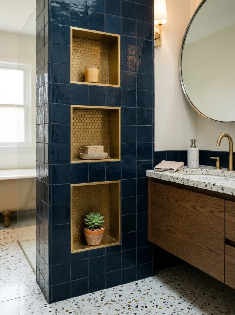 Series of small shallow wall niches in a bathroom holding candles and toiletries