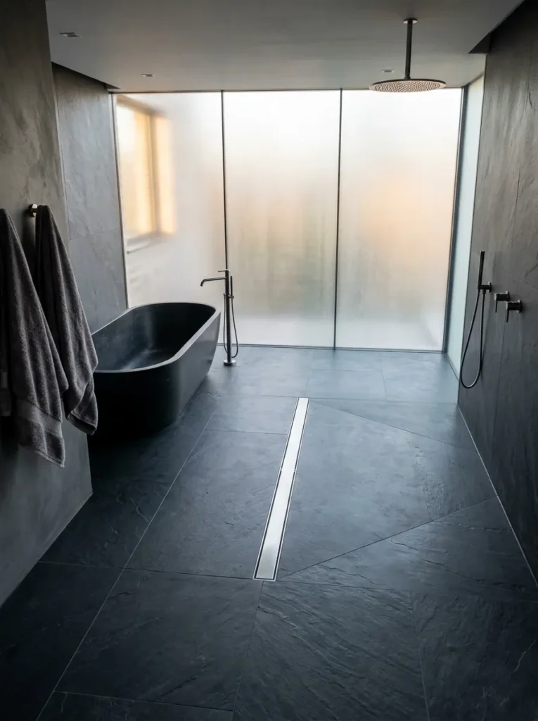 Open-plan wet room bathroom with no shower threshold and a central linear floor drain